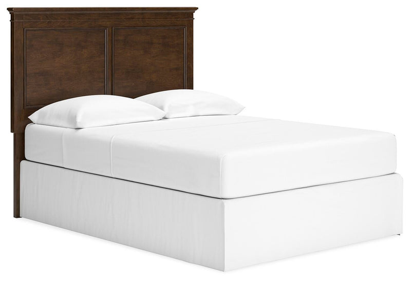 Ashley Furniture Danabrin panel storage bed shown from an angled side view with built-in storage drawers and a modern design.