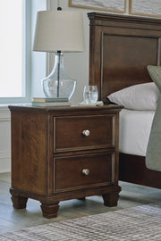 Ashley Furniture Danabrin nightstand with a dark wood finish, featuring a single drawer and open shelf for bedside storage.