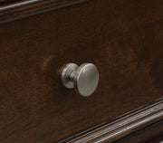 Close-up of the drawer knob on the Ashley Furniture Danabrin Nightstand, showing its detailed metallic finish and sleek design.