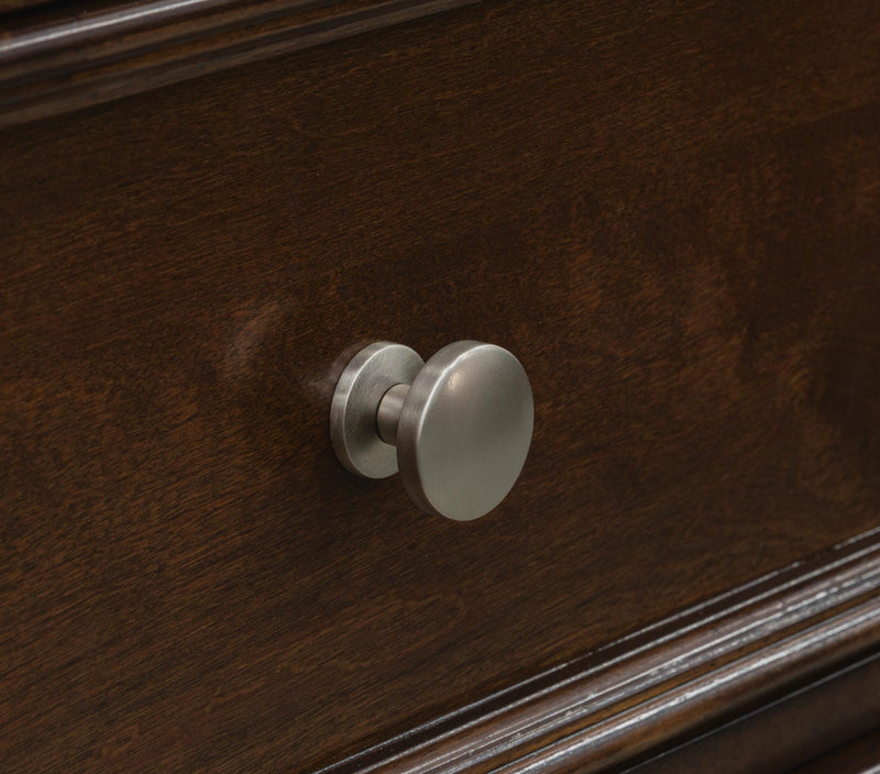 Close-up of the drawer knob on the Ashley Furniture Danabrin Nightstand, showing its detailed metallic finish and sleek design.