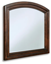 Ashley Furniture Porter bedroom mirror with a sleek, modern design shown from an angled view.