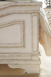 Detailed view of the Ashley Furniture Realyn Bedroom Set, showcasing the elegant wood finish and stylish bed frame.