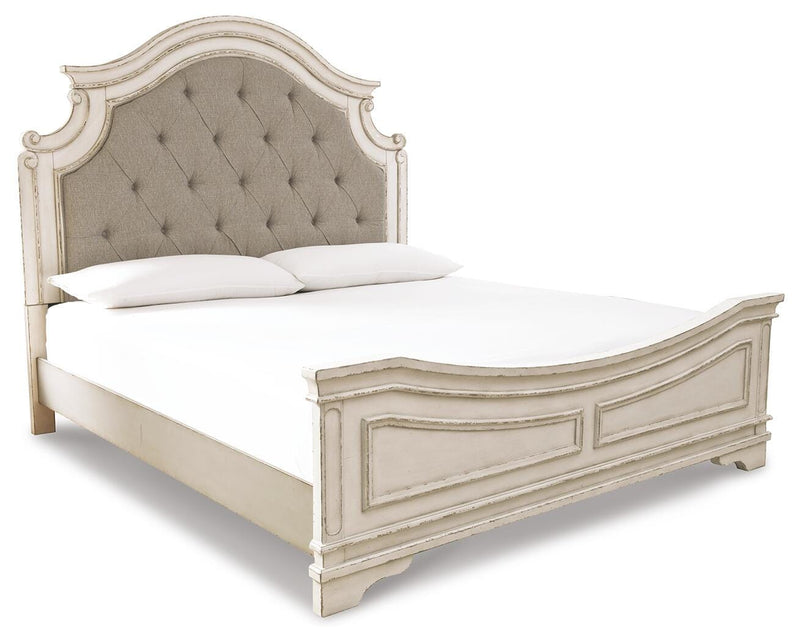 Ashley Furniture Realyn upholstered bed with a plush fabric headboard and wooden frame, shown in a stylish bedroom setting