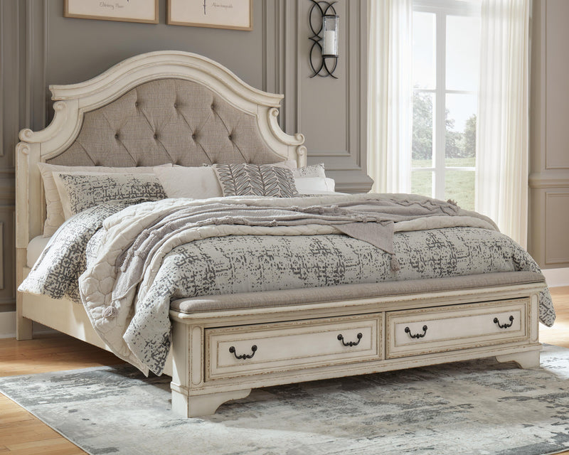 Ashley Furniture Realyn upholstered bed with a plush fabric headboard and wooden frame, shown in a modern bedroom setting.