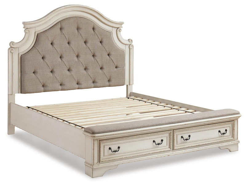 Ashley Furniture Realyn upholstered bed with a padded headboard, shown from an angled side view in a modern bedroom setting.