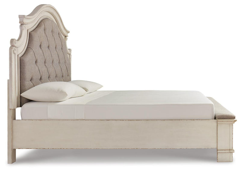 Ashley Furniture Realyn upholstered bed with beige fabric, wooden frame, and side view showing headboard and mattress support.