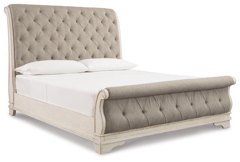 Ashley Furniture Realyn Bedroom Set shown from an angle with a bed, nightstands, and matching furniture in a modern bedroom.