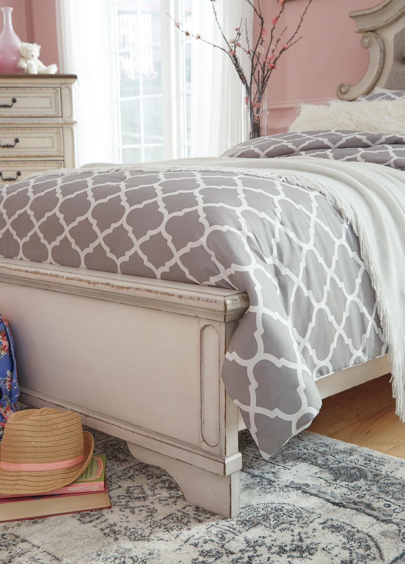 Close-up of the Ashley Furniture Realyn upholstered bed featuring soft fabric and detailed headboard design.