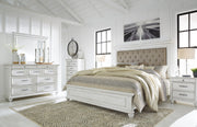 Ashley Furniture Kanwyn bedroom set featuring a bed, nightstands, and dresser in a modern bedroom decor style.