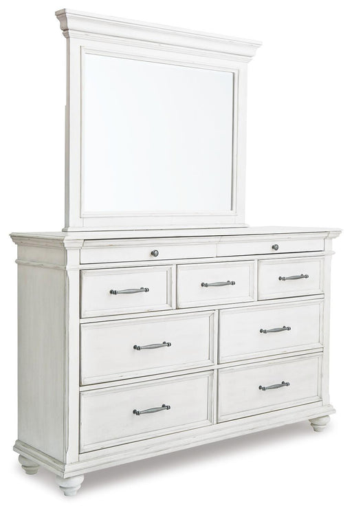 Ashley Furniture Kanwyn dresser and mirror set showing a modern wooden dresser with a matching mirror in a bedroom setting.