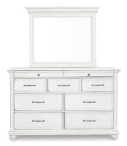 Ashley Furniture Kanwyn bedroom set featuring a bed with a headboard, matching nightstands, and a dresser in a modern bedroom scene.