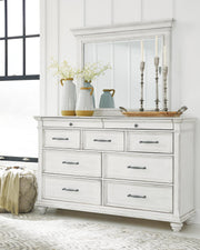 Ashley Furniture Kanwyn Bedroom Set with bed frame, nightstands, and dresser in a modern bedroom interior.