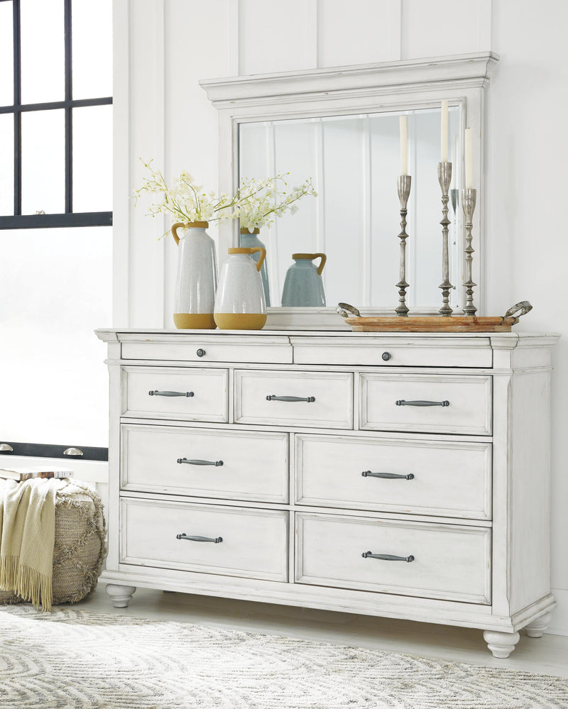 Ashley Furniture Kanwyn Bedroom Set with bed frame, nightstands, and dresser in a modern bedroom interior.