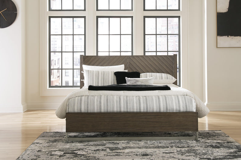 Ashley Furniture Arkenton King Bedroom Set featuring a large bed with a wooden headboard and matching nightstands.