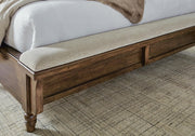 Ashley Furniture Sturlayne upholstered bed with a padded headboard and neutral fabric, showcasing a stylish bedroom centerpiece.