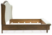 Ashley Furniture Sturlayne upholstered bed with a padded headboard and stylish design, shown from a side angle.