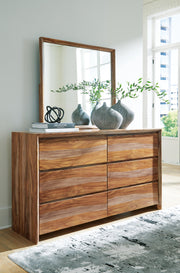 Ashley Furniture Dressonni bedroom set with a stylish bed, matching nightstands, and dresser in a modern bedroom layout.