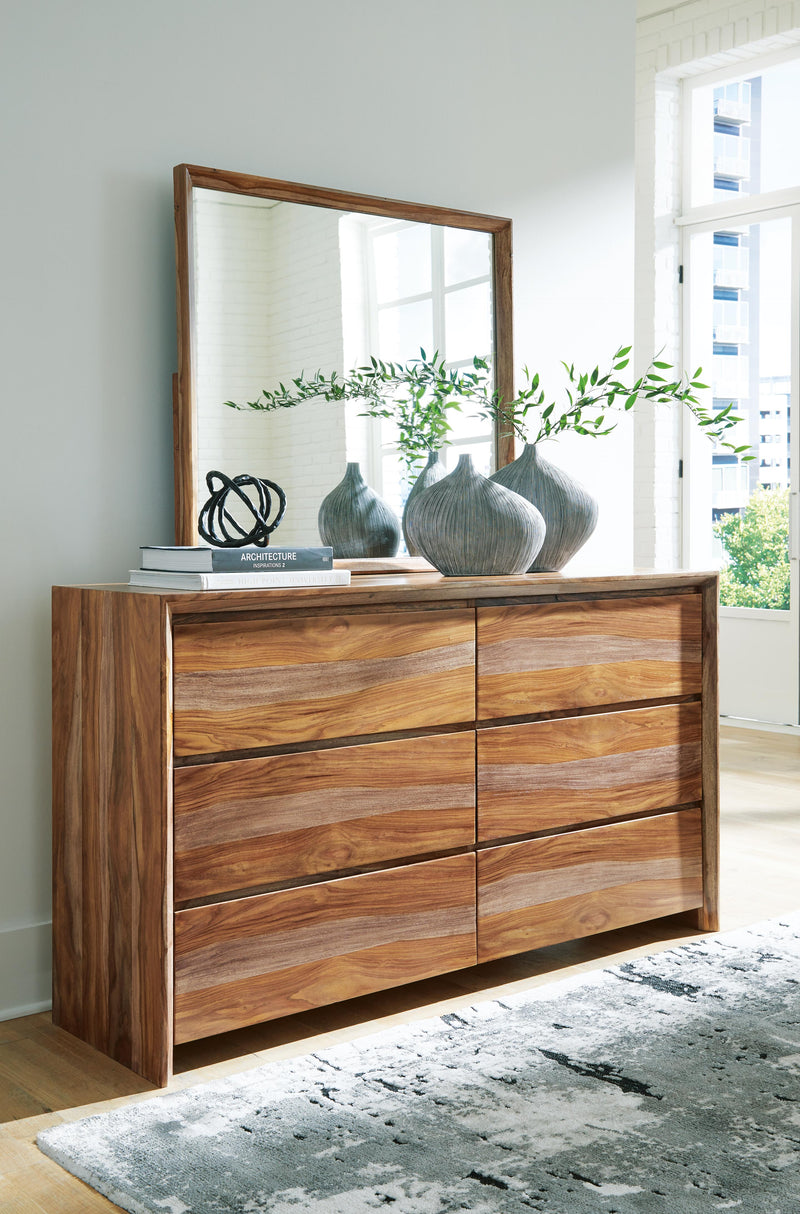 Ashley Furniture Dressonni bedroom set with a stylish bed, matching nightstands, and dresser in a modern bedroom layout.