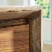 Ashley Furniture Dressonni nightstand with beveled frame, featuring a sleek wood finish and modern design details.