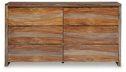 Ashley Furniture Dressonni dresser showcasing sleek wood finish and modern design with multiple drawers for storage.