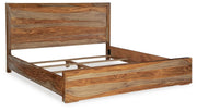 Ashley Furniture Dressonni bedroom set with bed, nightstands, and dresser, shown from an angled view in a modern bedroom setting.