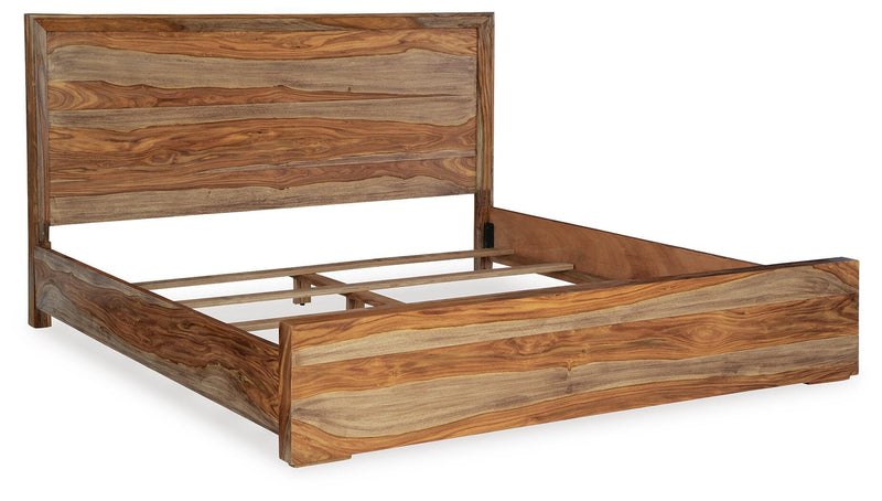 Ashley Furniture Dressonni bedroom set with bed, nightstands, and dresser, shown from an angled view in a modern bedroom setting.