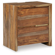 Ashley Furniture Dressonni nightstand with a closed drawer, sleek wood finish, and modern design viewed from an angled side.