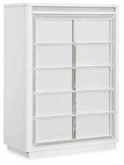 Ashley Furniture Chalanna chest of drawers, angled view showing sleek wooden finish and multiple storage drawers.