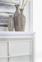 Ashley Furniture Chalanna chest of drawers with sleek wood finish and modern design, featuring multiple spacious drawers.