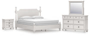 Ashley Furniture Rowlenstown bedroom set with bed frame, dresser, and nightstands in a cozy, stylish bedroom scene.