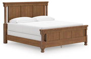 Ashley Furniture Chadworth Bed with a classic wooden frame, showcasing a sleek and sturdy design from a side and angle view.