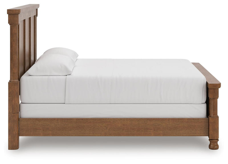 Ashley Furniture Rowlenstown bedroom set featuring a neatly made bed with matching nightstands and a cozy, stylish bedroom decor.