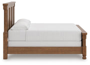 Ashley Furniture Rowlenstown bedroom set with a stylish bed, matching nightstands, and cozy bedding in a modern bedroom scene.