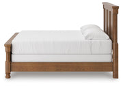 Ashley Furniture Rowlenstown bedroom set featuring a bed frame, nightstands, and matching decor in a modern bedroom setting.