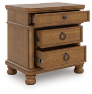 Ashley Furniture Rowlenstown bedroom set shown from an angle, including bed frame, nightstands, and dresser in a modern bedroom layout.