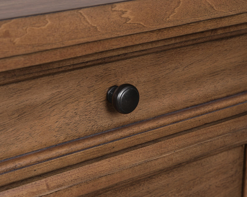 Close-up of Ashley Furniture Chadworth Chest of Drawers showing detailed wooden knobs and rich wood finish.