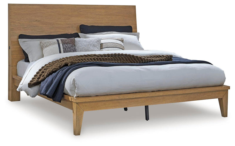 Ashley Furniture Sherbana Bed with upholstered headboard and sleek wooden frame, shown in a modern bedroom setting.