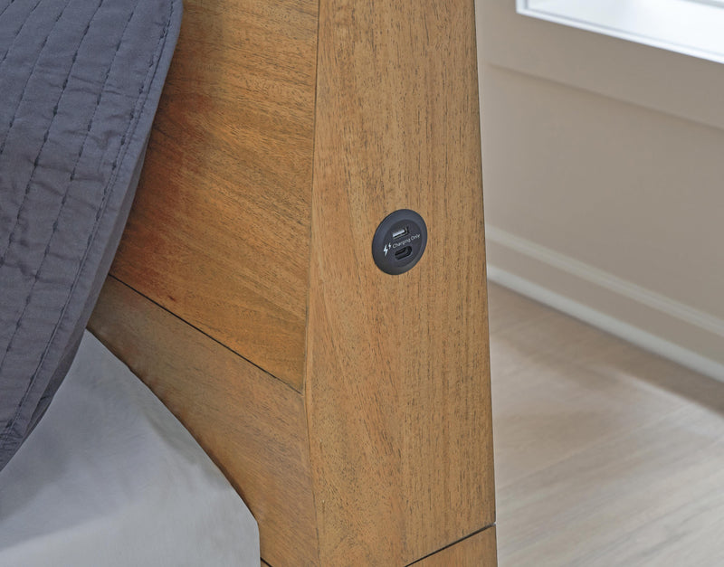 Ashley Furniture Sherbana Bed with upholstered headboard and wood frame, shown in a detailed close-up image.