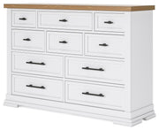 Ashley Furniture Ashbryn dresser with multiple drawers and a sleek wood finish, viewed from an angled perspective.