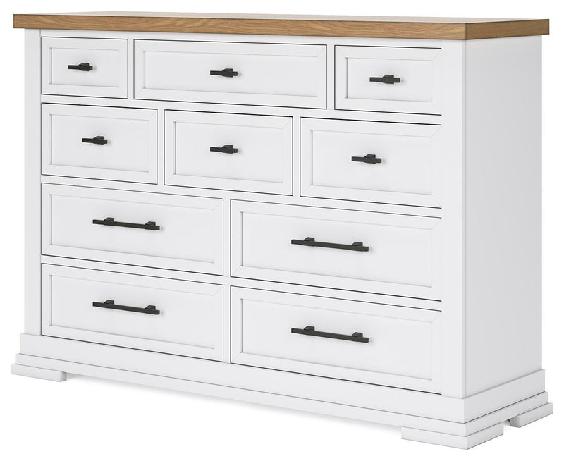 Ashley Furniture Ashbryn dresser with multiple drawers and a sleek wood finish, viewed from an angled perspective.