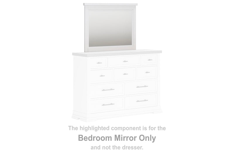 Ashley Furniture Ashbryn bedroom mirror with a sleek wooden frame, reflecting a modern bedroom decor.