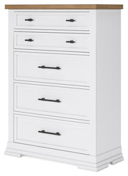 Ashley Furniture Ashbryn chest of drawers with angled view showcasing wood finish and multiple drawer fronts.