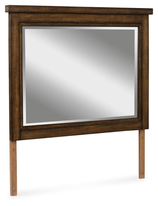 Ashley Furniture Taffenbrook bedroom mirror showing a large, framed mirror with a sleek wooden finish, angled to display its reflective surface.