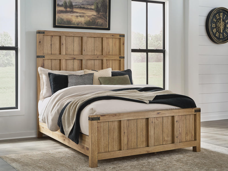 Ashley Furniture Ridgester Bed with upholstered headboard and wooden frame, shown in a cozy bedroom setting.