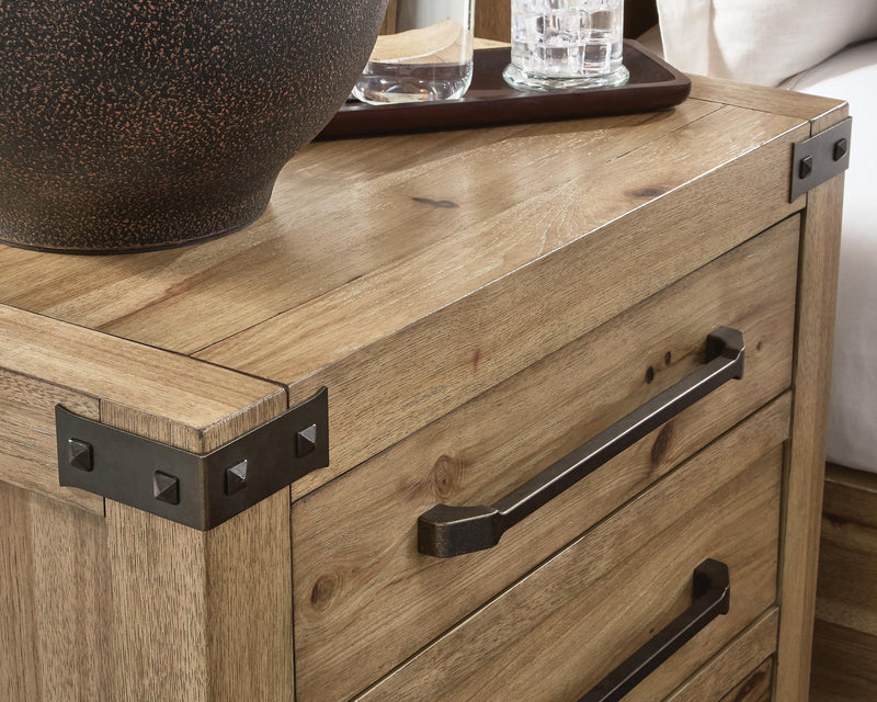 Close-up of Ashley Furniture Ridgester nightstand handle and bracket detail showing the dark wood finish and modern design.