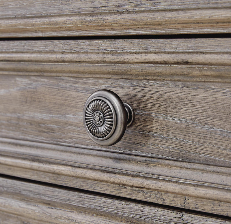 Close-up of Ashley Furniture Blairhurst Chest of Drawers with detailed wooden drawer knobs and rich finish.