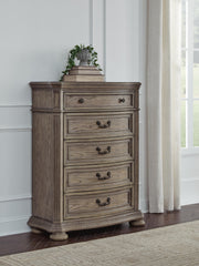Ashley Furniture Ardenfield chest of drawers with a dark wood finish and multiple storage drawers, showcasing a sturdy bedroom storage piece.
