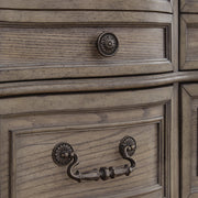 Close-up of the hardware details on the Ashley Furniture Ardenfield Dresser showing drawer handles and wood finish.