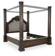 Ashley Furniture Maylee Bed with upholstered headboard and wooden frame, shown from an angled side view.