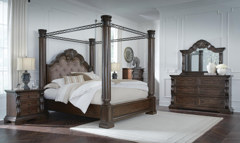 Ashley Furniture Maylee Bed with upholstered headboard and wooden frame, shown in a cozy bedroom setting.